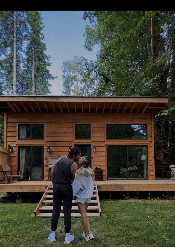 Standing in front of a finished cabin